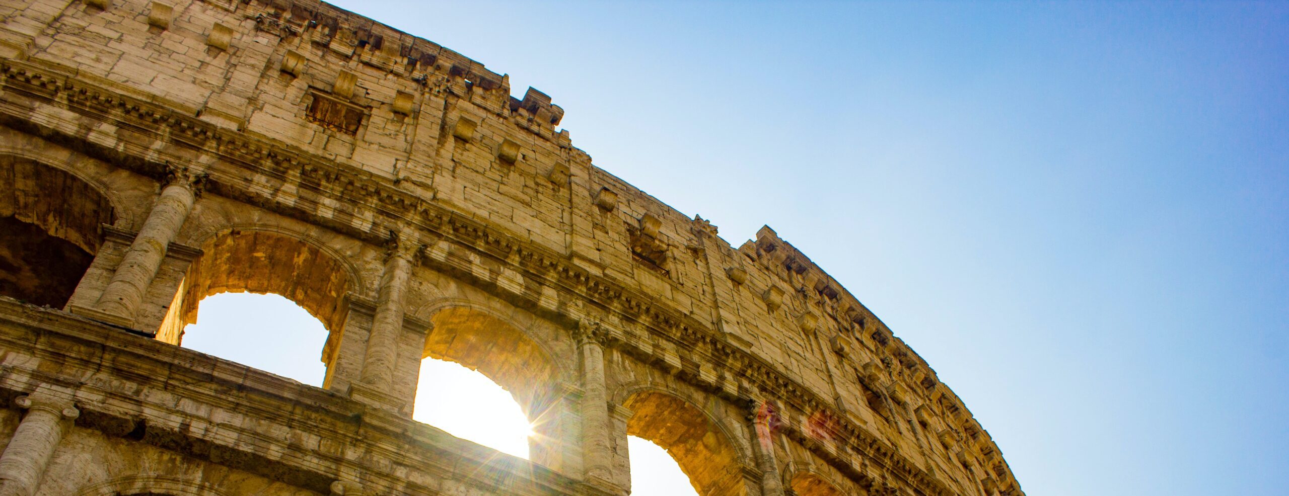 Looking up at the Colosseum in Rome on a sunny day.